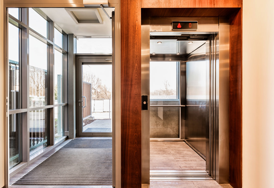glass door and an elevator